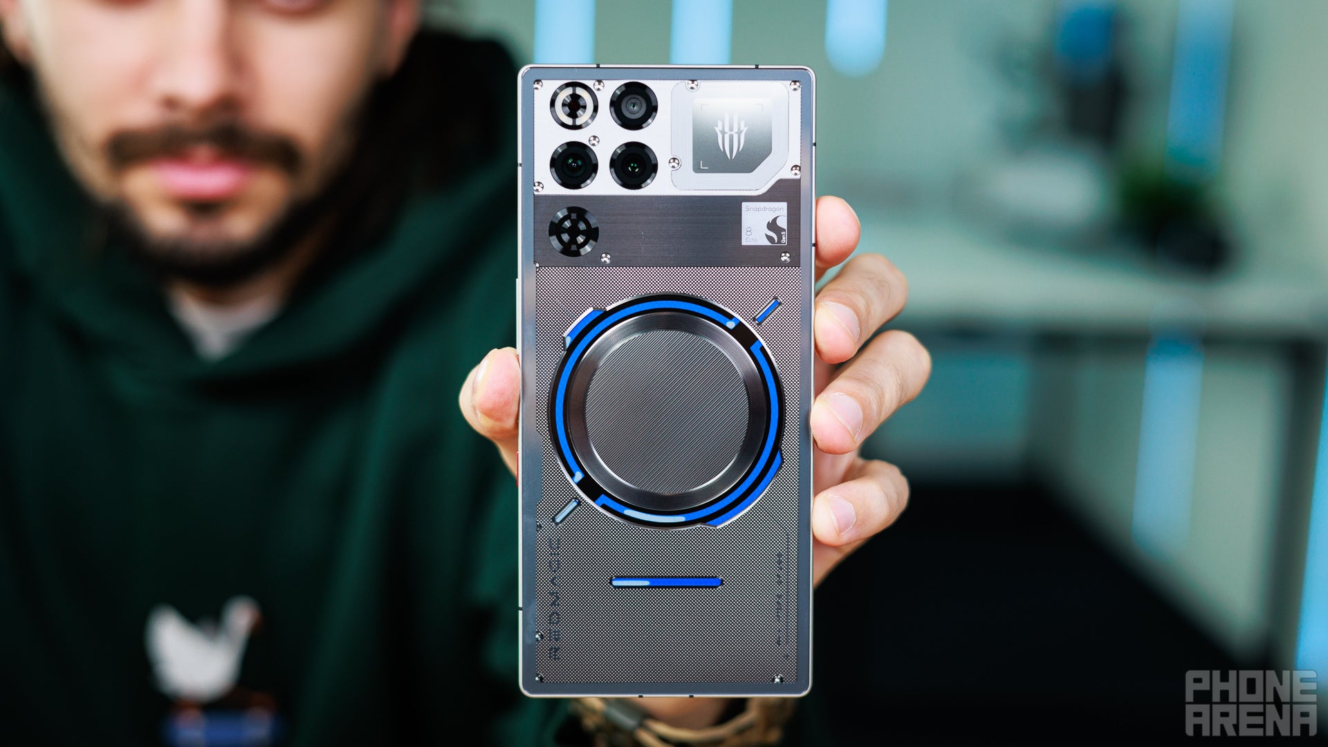 A man showing the rear view of RedMagic 11 Pro.