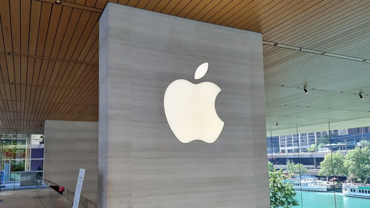 Apple&amp;#039;s logo displayed on a grey wall.