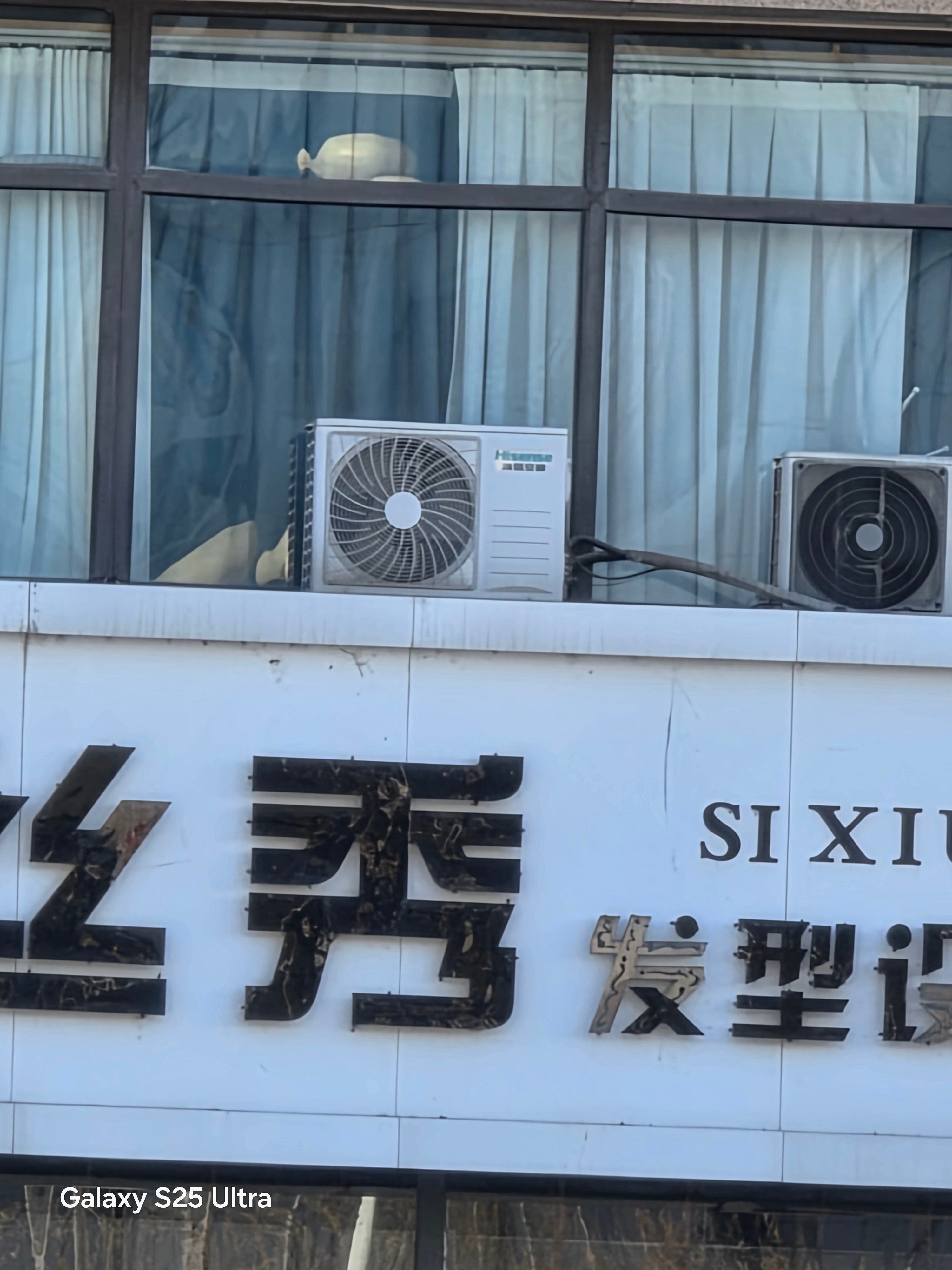 A photo of a air conditioner on a building.
