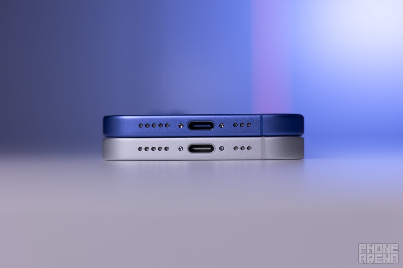 iPhone 16 and iPhone 16e bottom edge comparison, USB-C port and speaker grille detail.