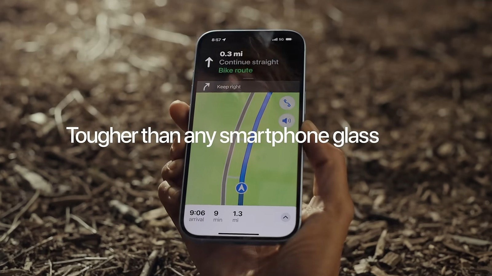 iPhone held outdoors showing Maps navigation on screen