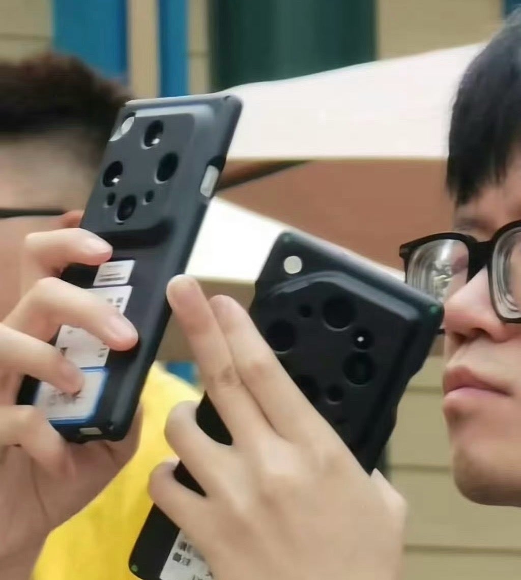 A man with a phone in hand. The phone has a thick case.