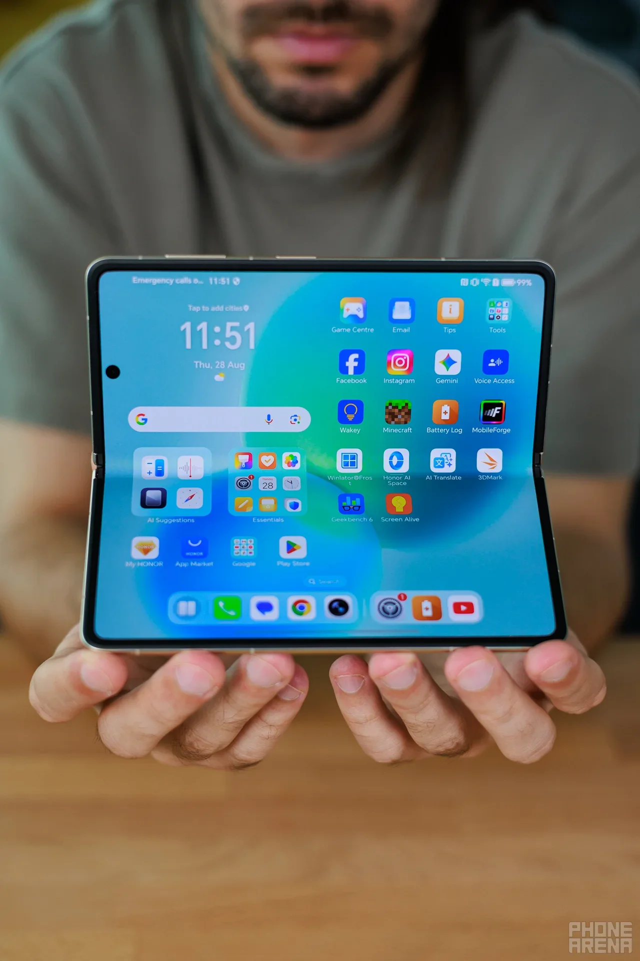 A man holding a phone by Honor.