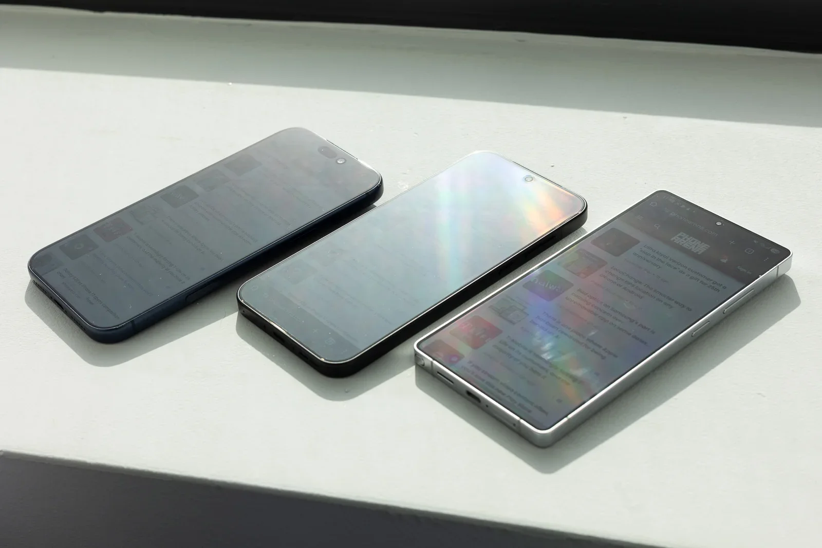 Three phones on a desk.