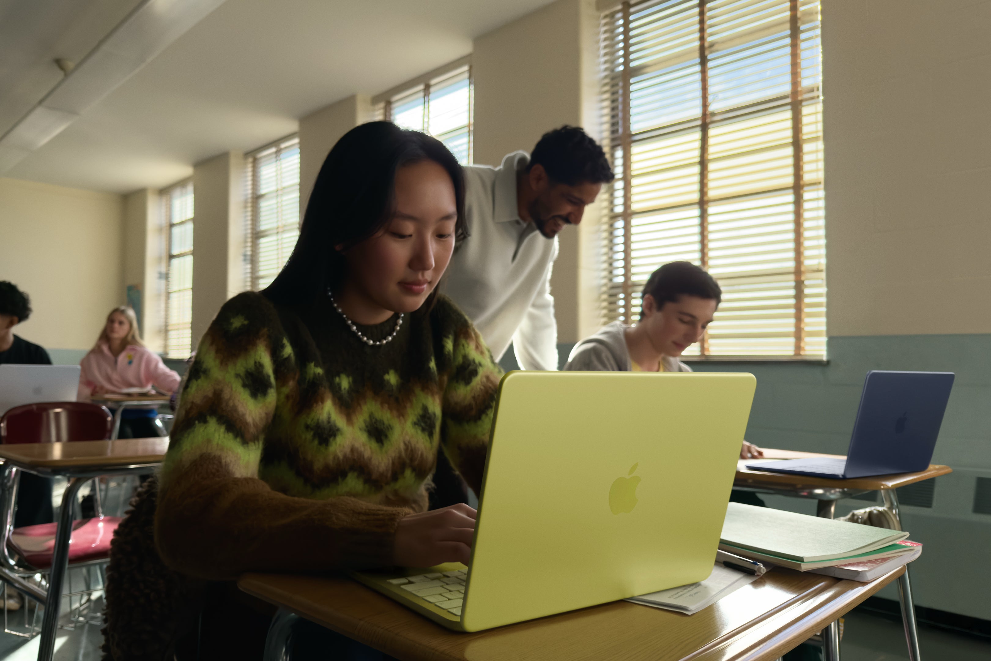 Student sitting with a MacBook Neo
