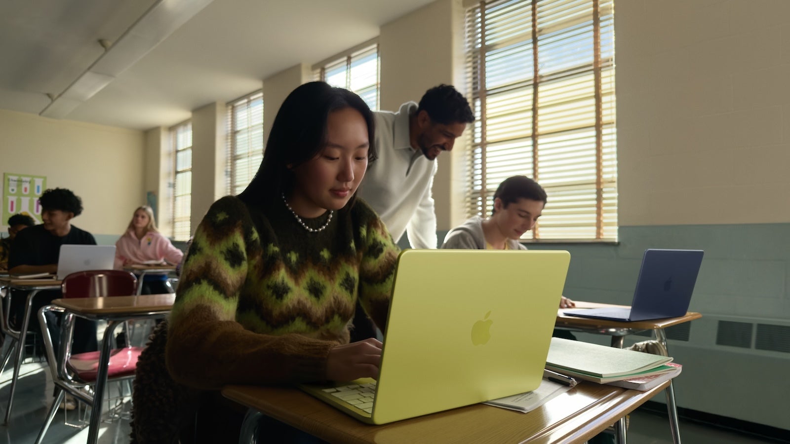 Student using Apple MacBook Neo laptop in classroom