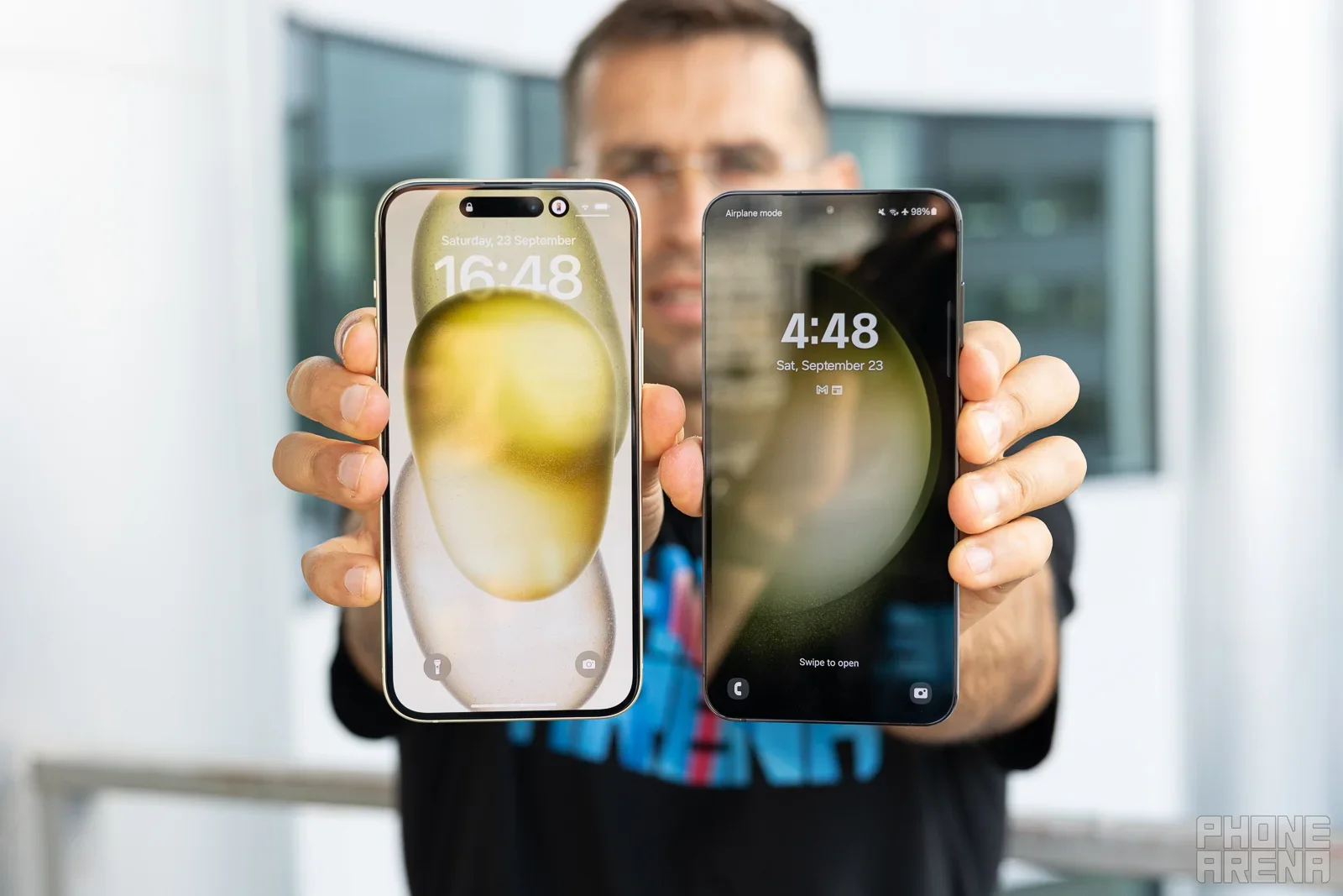 A man holding two phones.