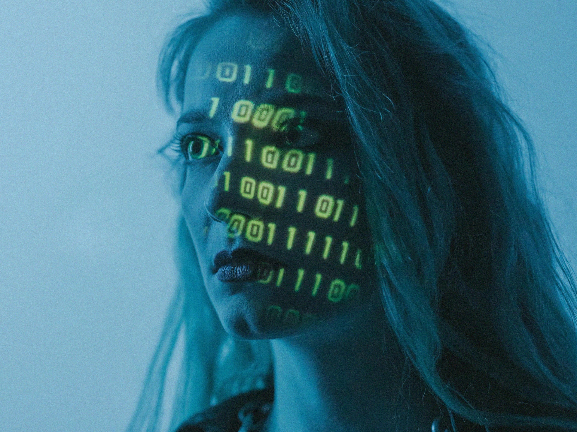 Woman with green numbers over face.