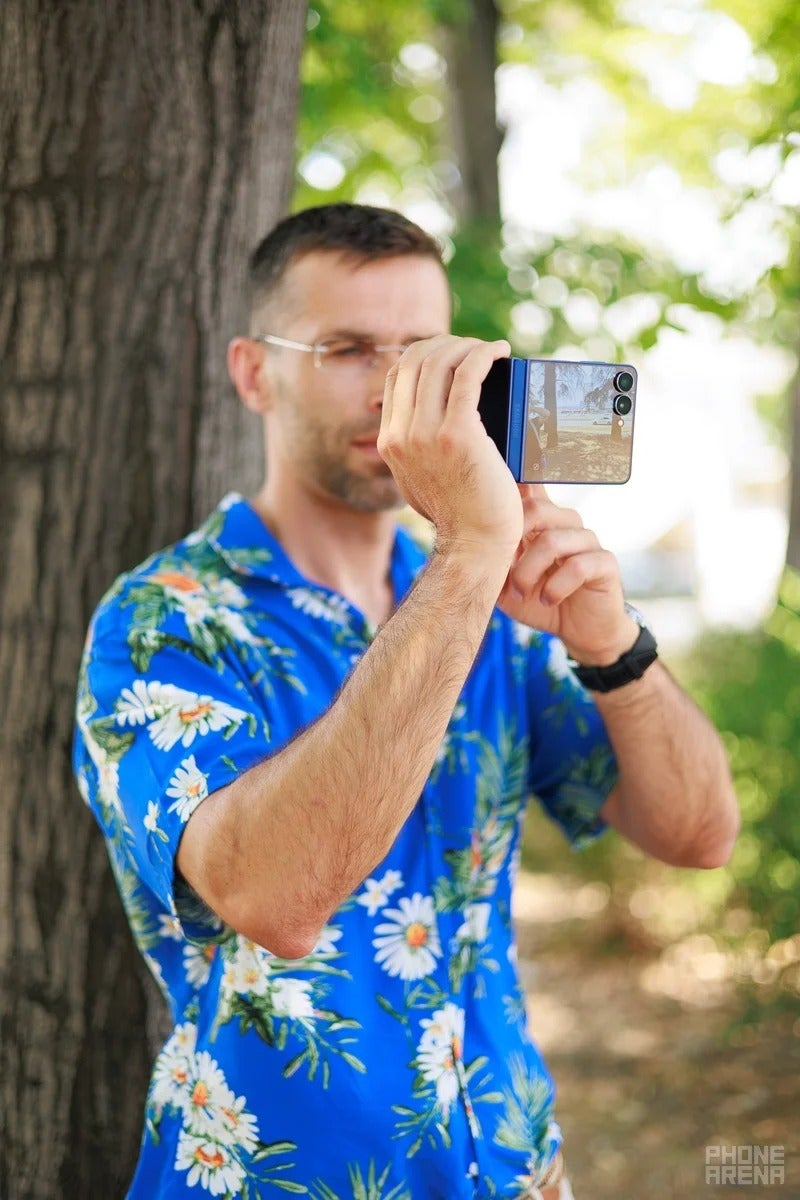 Person using a Galaxy Z Flip to take a photo outdoors