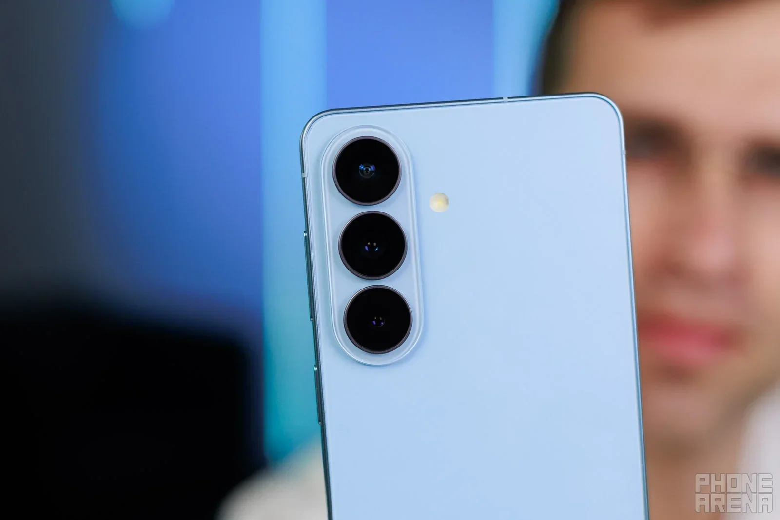 S26 phone held in hand.