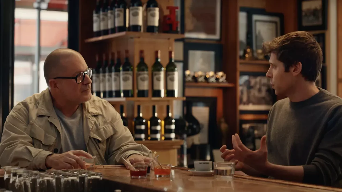 Two people at a table, talking to each other.