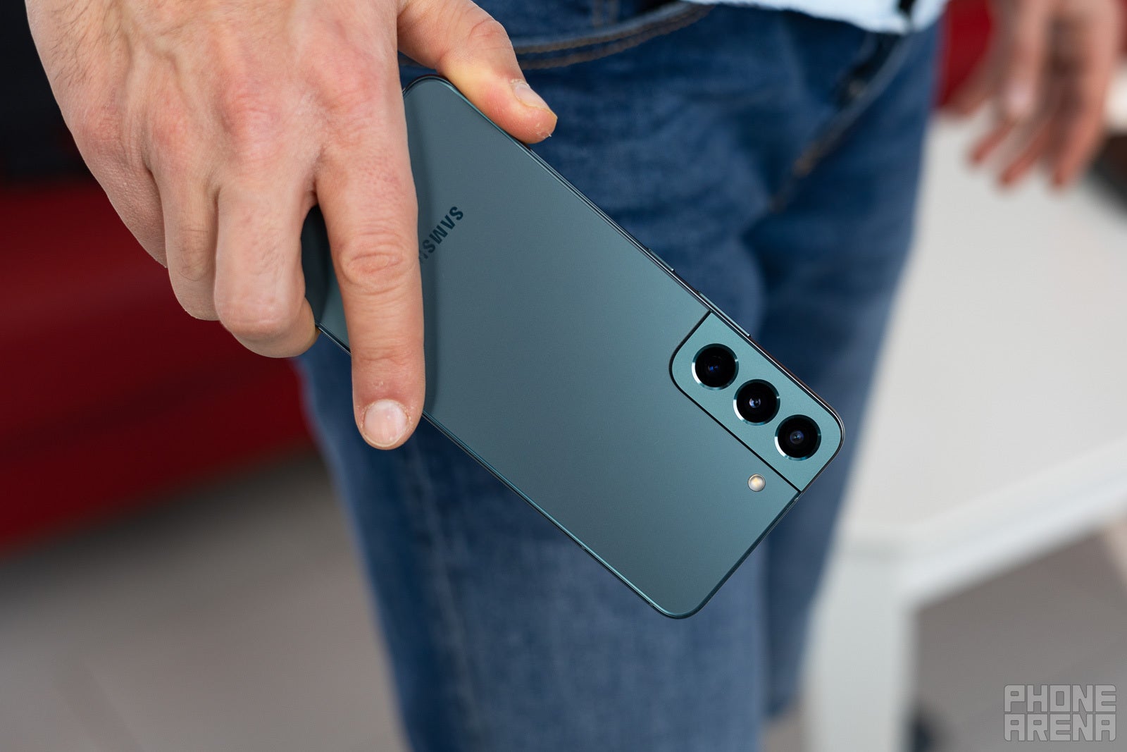 A man holding the Galaxy S22 in his hand.