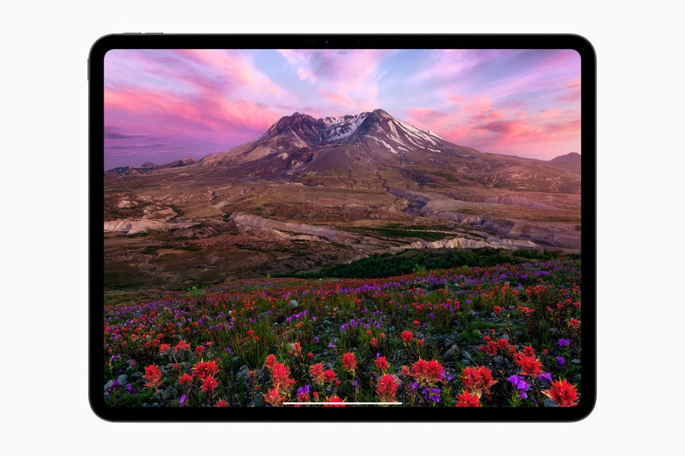 The M4 iPad Pro displaying a bright landscape scene on its Ultra Retina XDR tandem OLED screen.