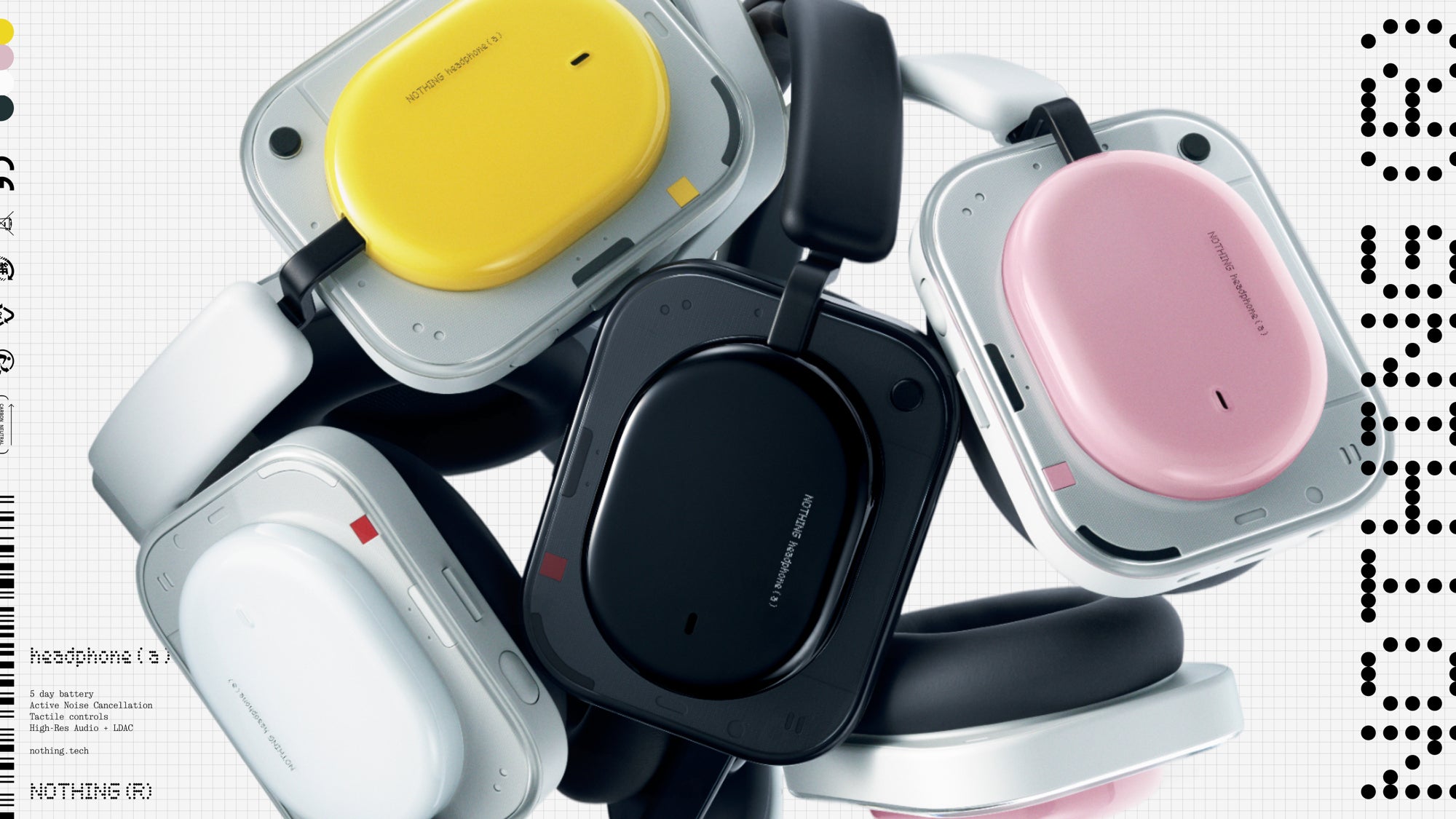 A pile of Nothing Headphone (a) units in yellow, black, pink and white, showing their transparent square ear cups.
