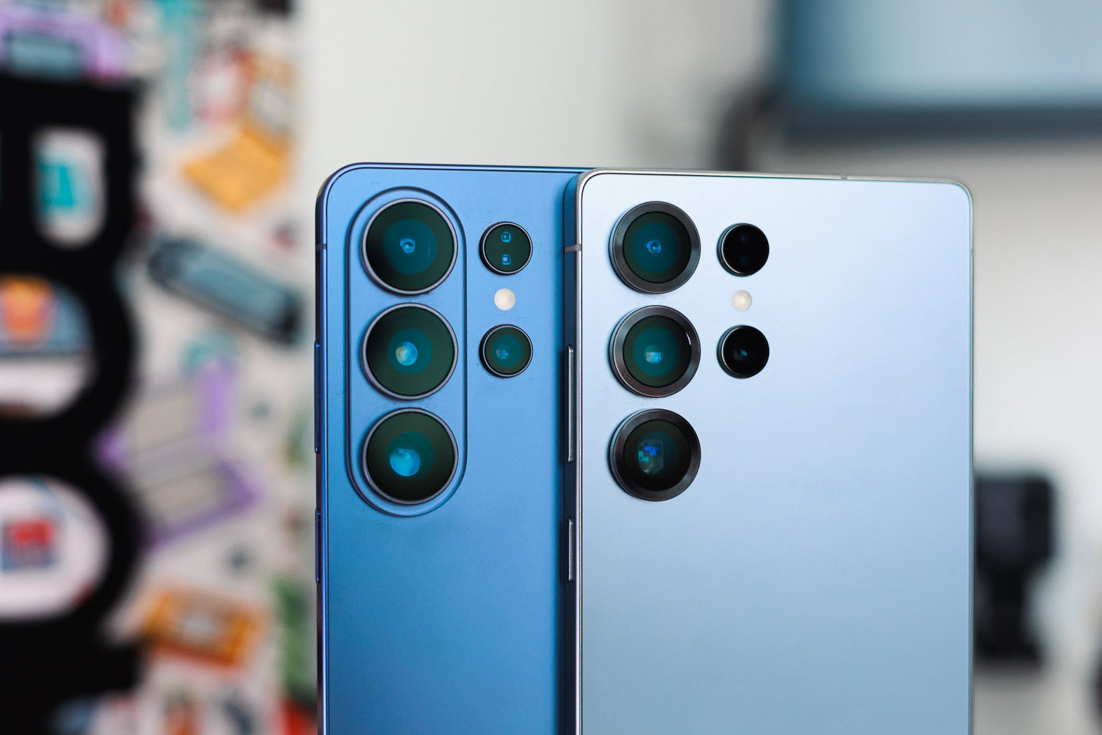 A blue and a light blue Galaxy S Ultra phones on a desk, closeup.