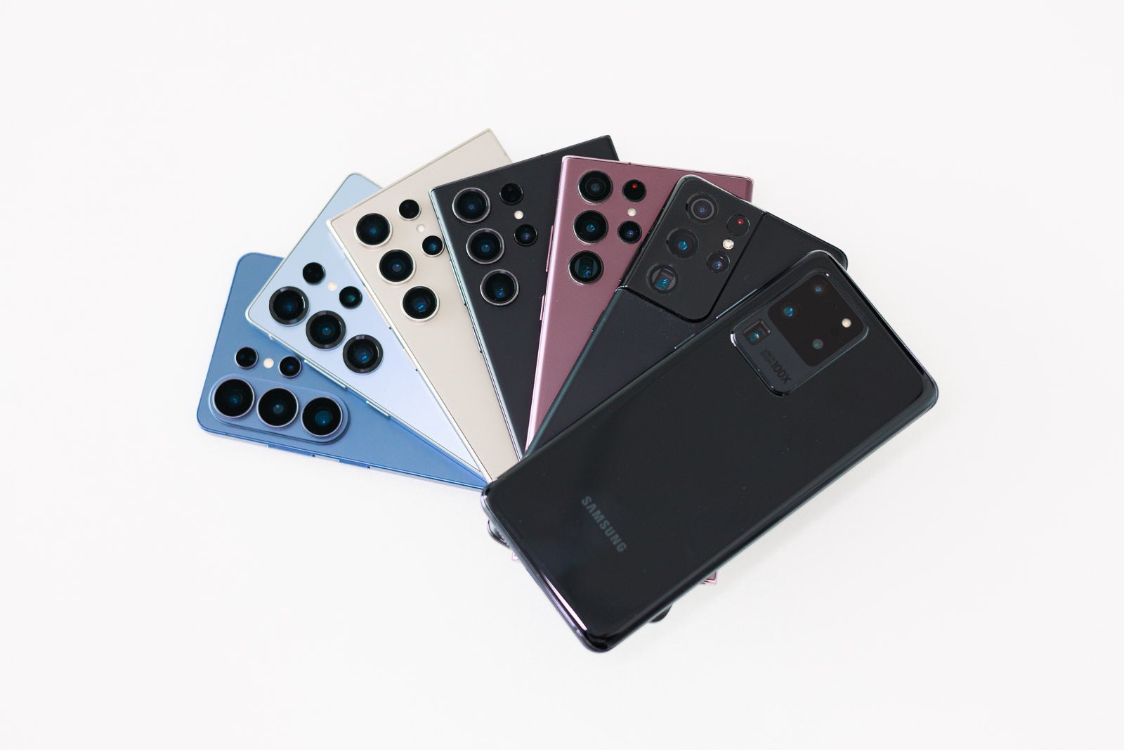 Seven Galaxy S Ultra phones arranged on a desk.