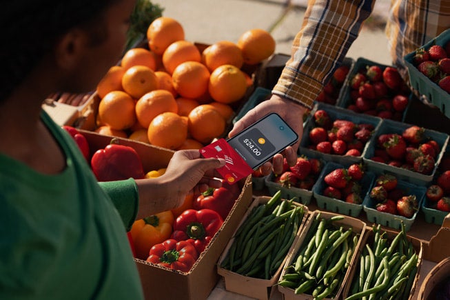 Merchant accepting a contactless payment via iPhone.