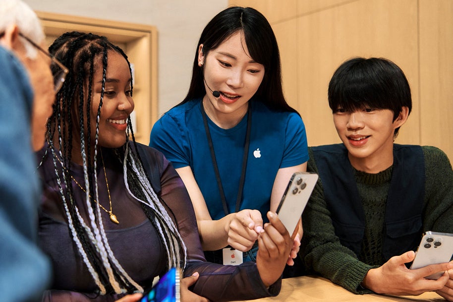 Apple Store specialist showing a customer an iPhone