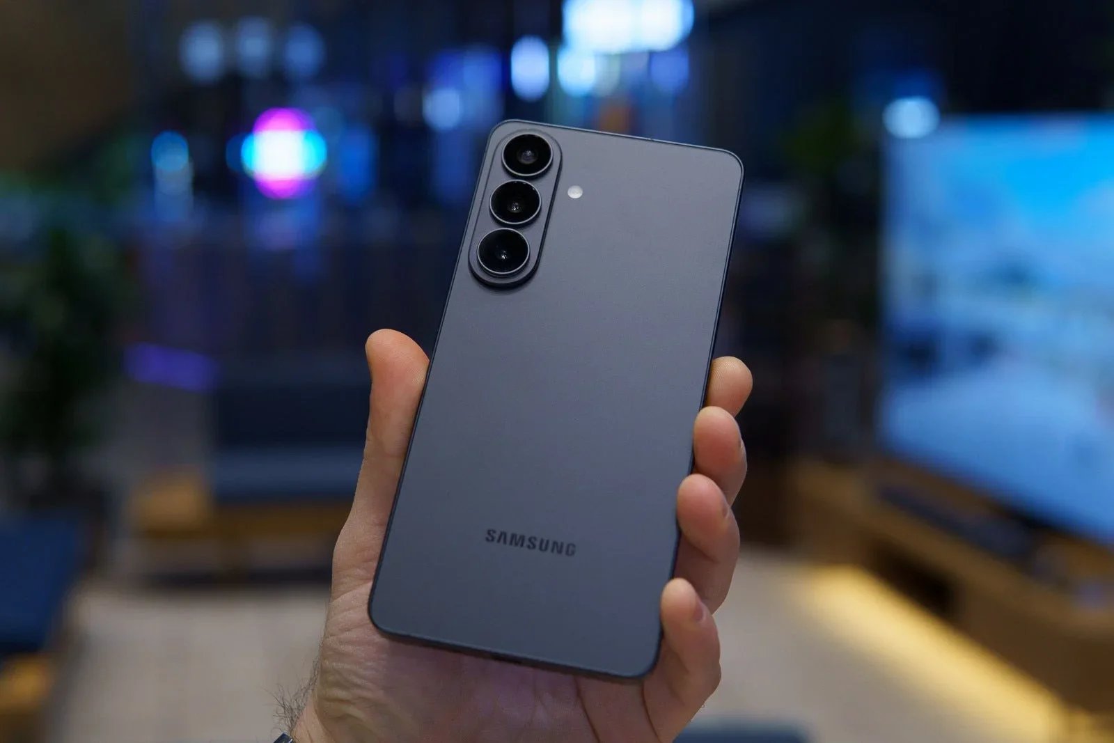 Samsung phone held in hand.