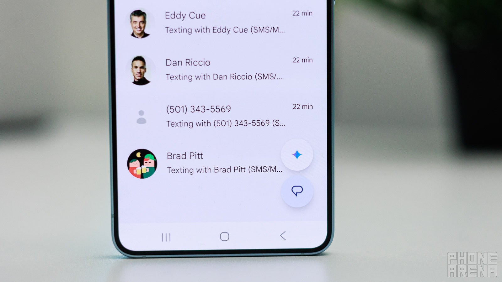 Close-up of Google Messages threads still running over SMS and MMS