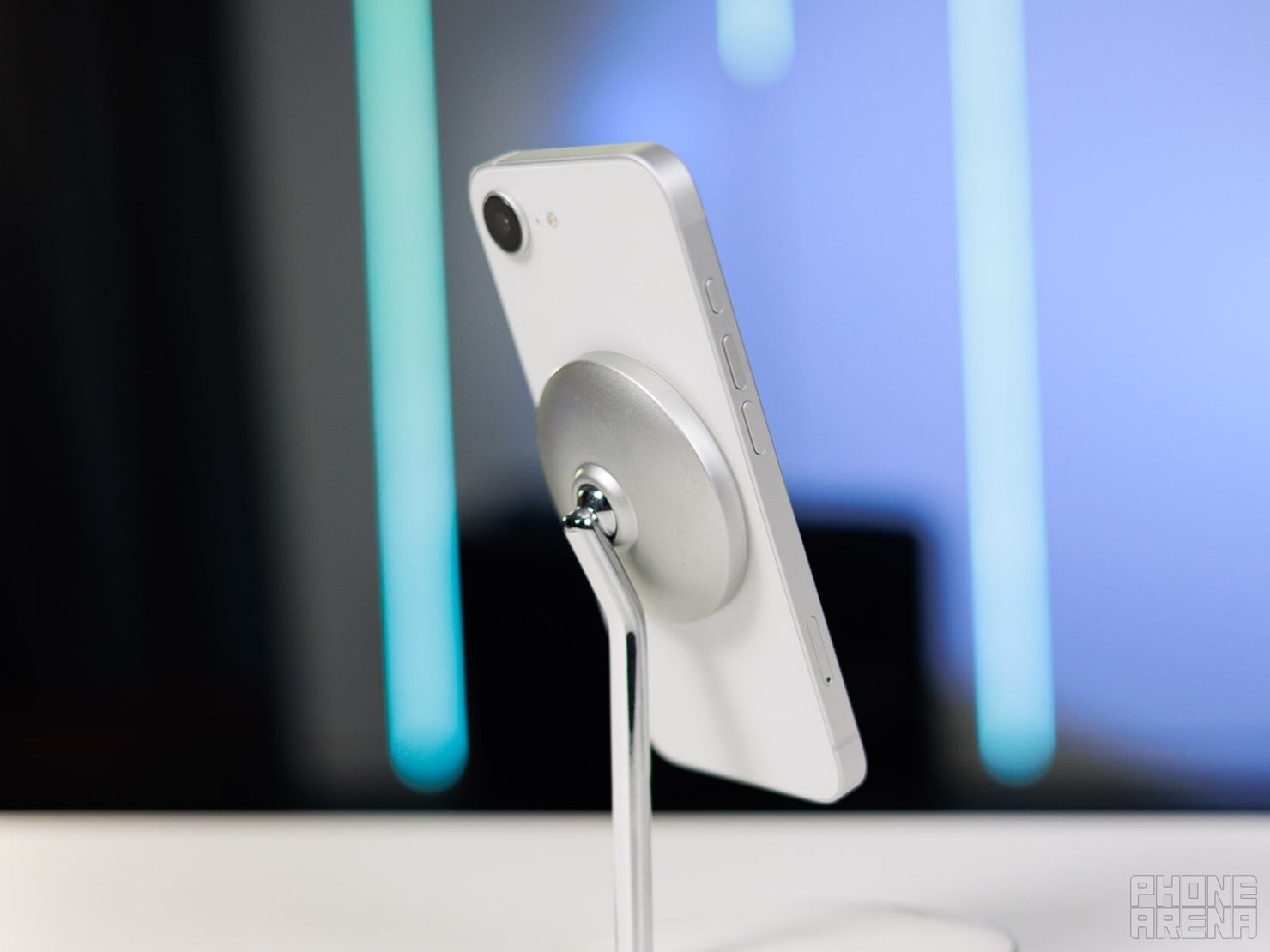 White iPhone Air charging wirelessly on a MagSafe stand