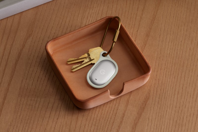 Google Pixel Tag in a holder clipped to a set of keys.