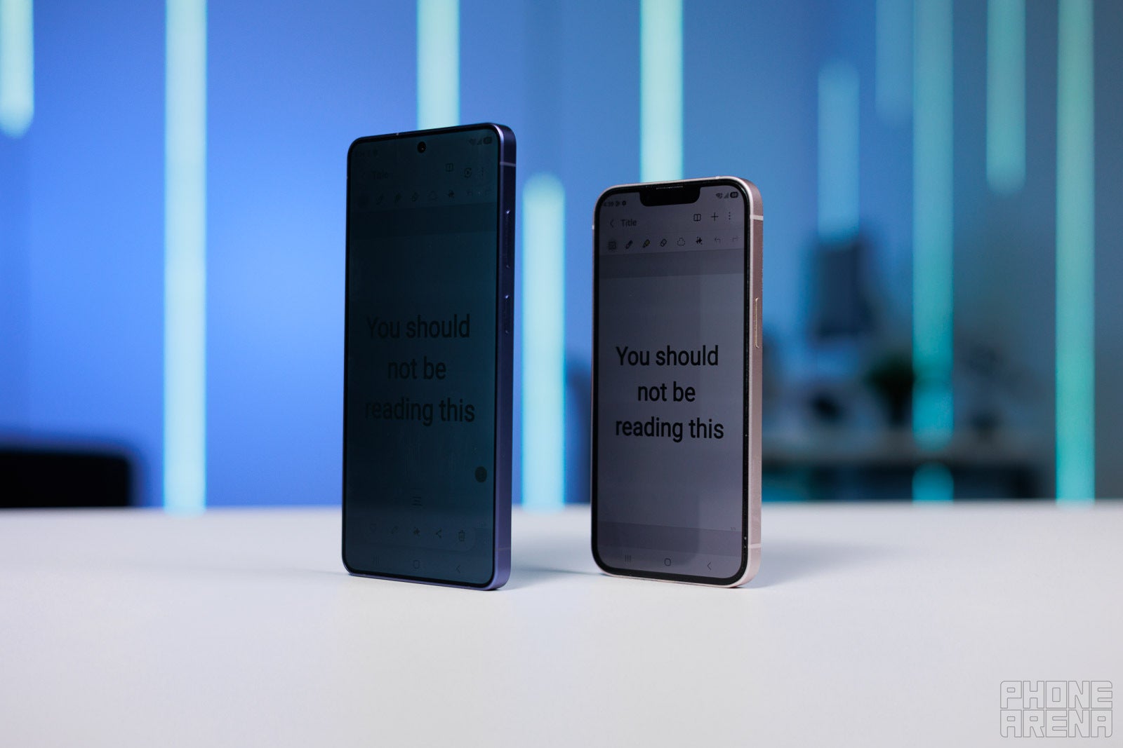 Galaxy S26 Ultra Privacy Display vs an actual privacy screen protector on iPhone | Image by PhoneArena - Galaxy S26 Ultra Privacy Display proves there&rsquo;s still room for hardware innovation in phones