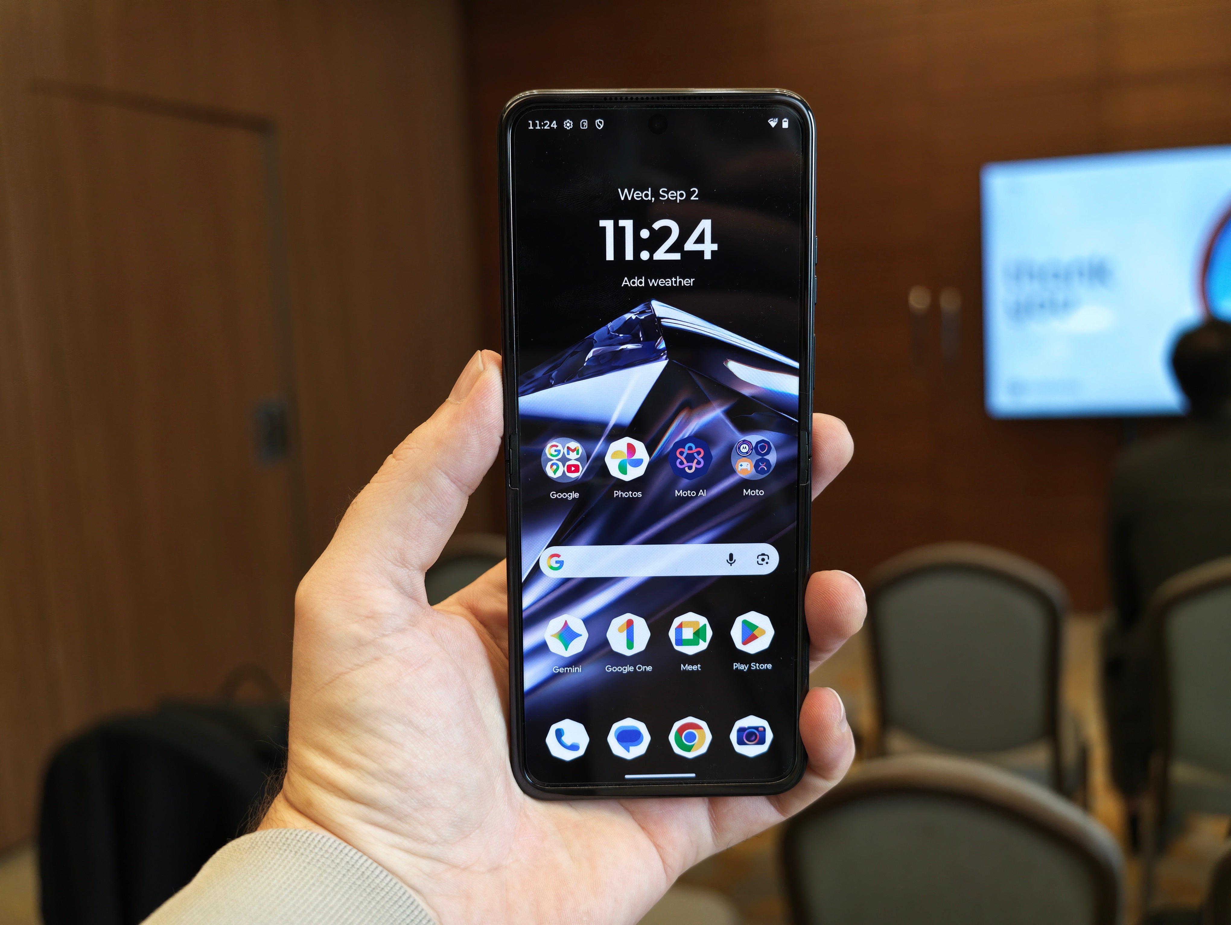Motorola razr 2026 unfolded in hand showing the home screen