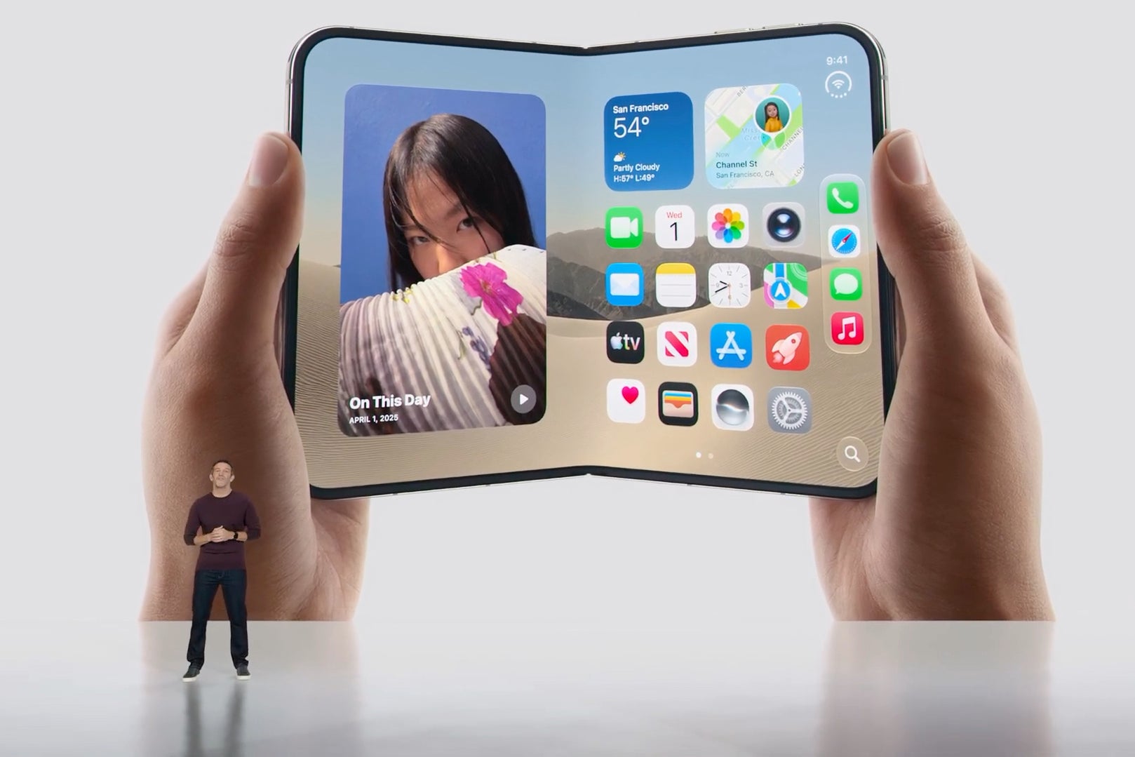 Apple CEO John Ternus on stage beside a large image of the unfolded iPhone Duo home screen