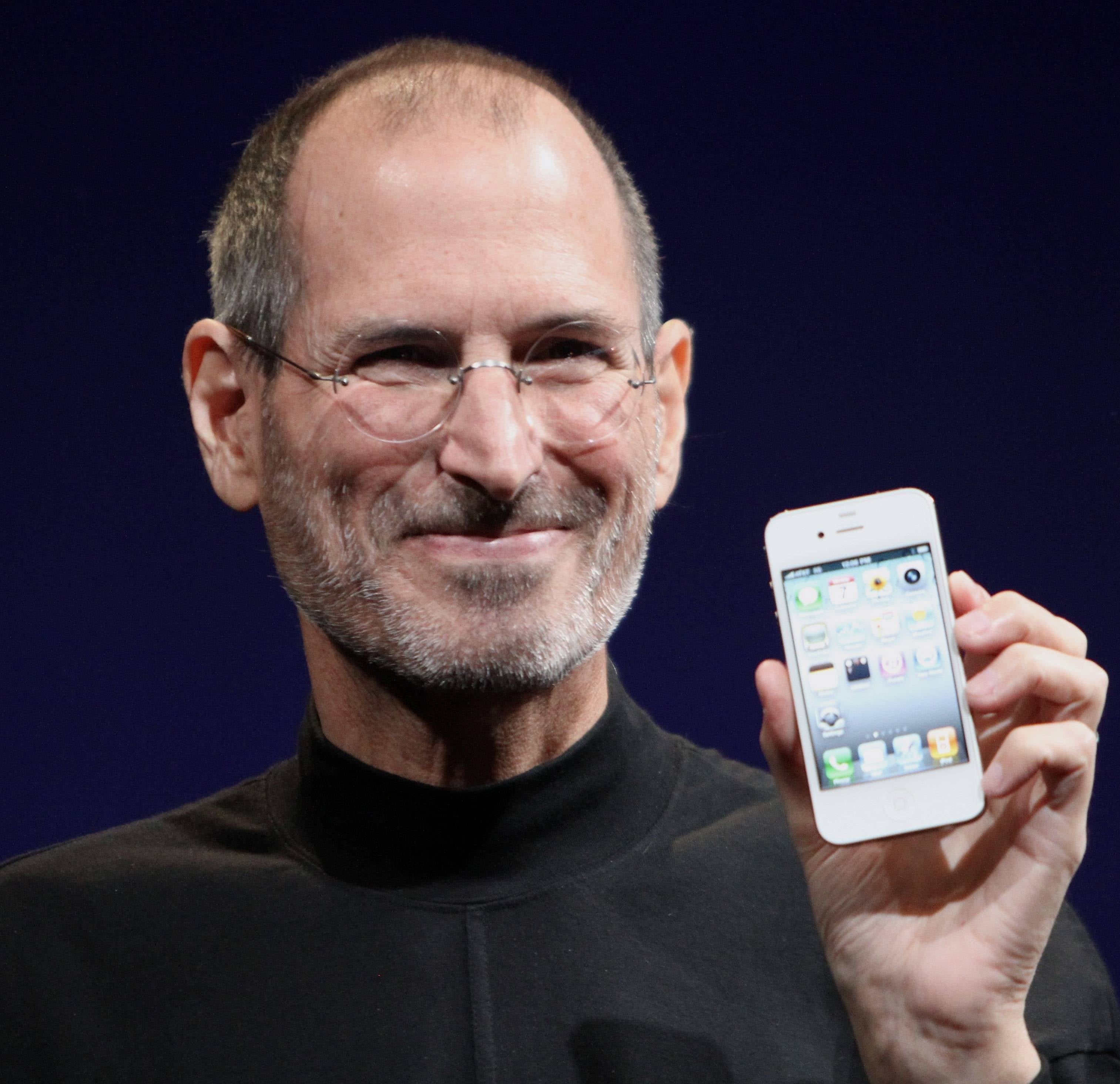 Apple co-founder and ex-CEO Steve Jobs shows off iPhone