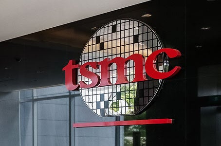 TSMC logo sign mounted in an office lobby