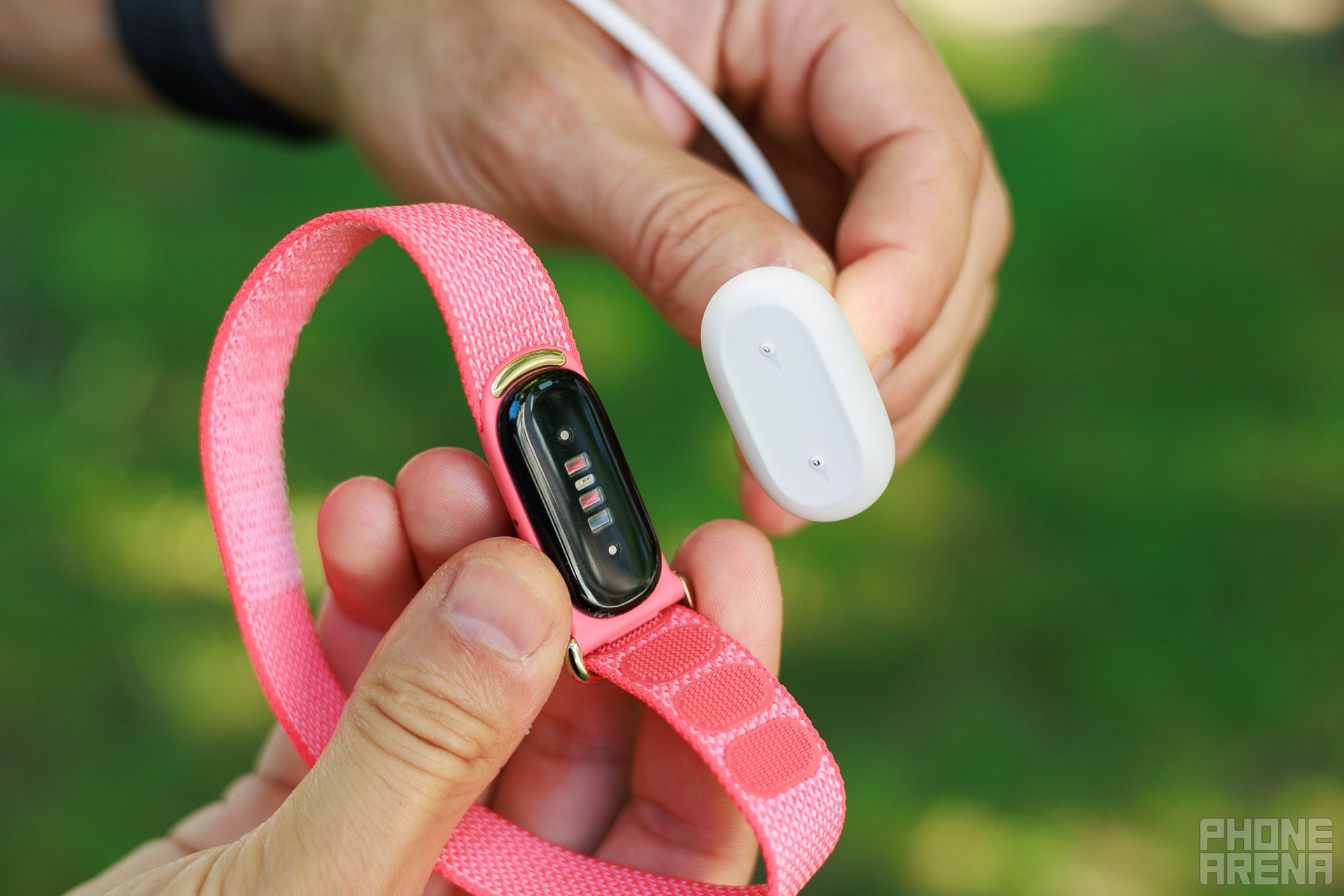 Fitbit Air sensor pod beside its magnetic charger