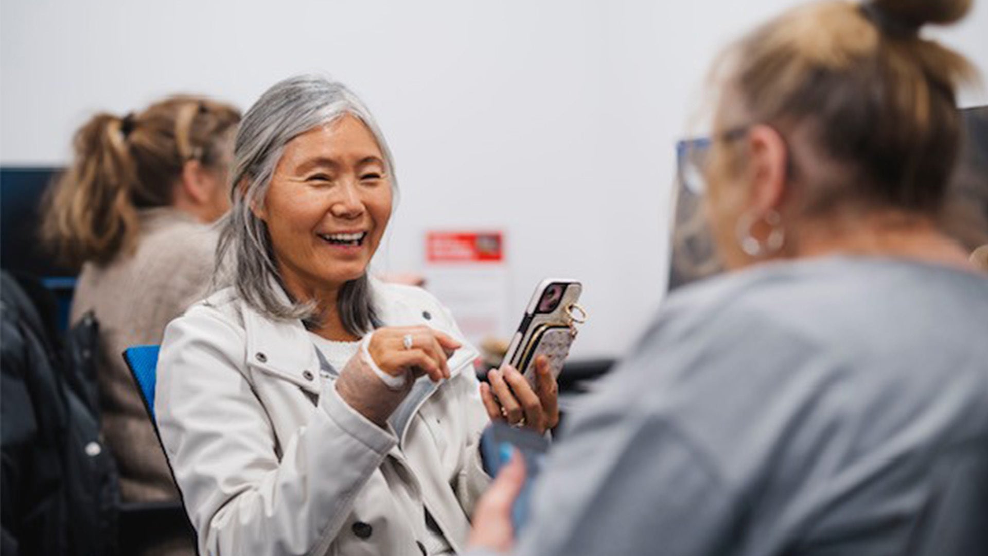 Woman holding a phone.