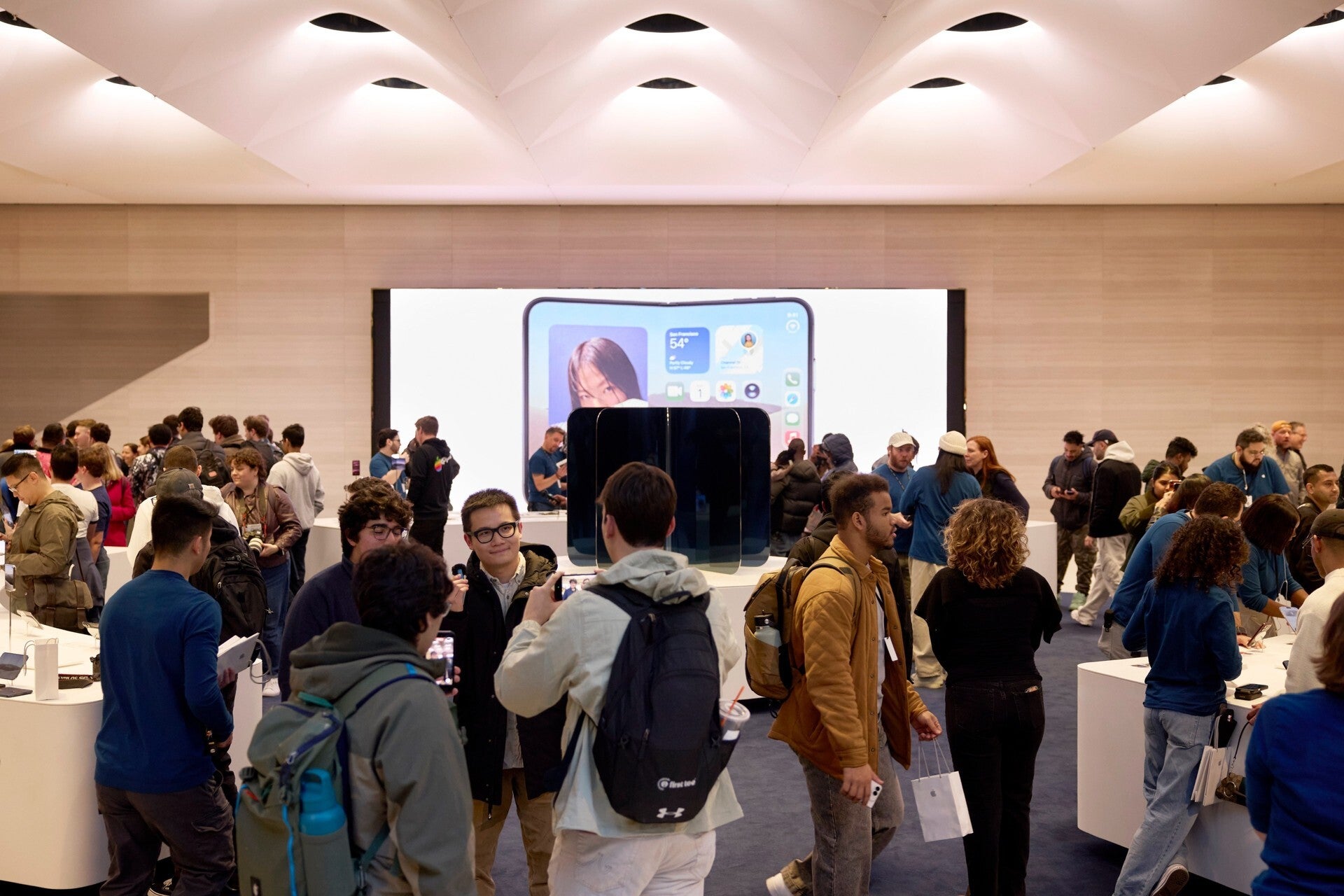 Apple Store team members helping customers at tables