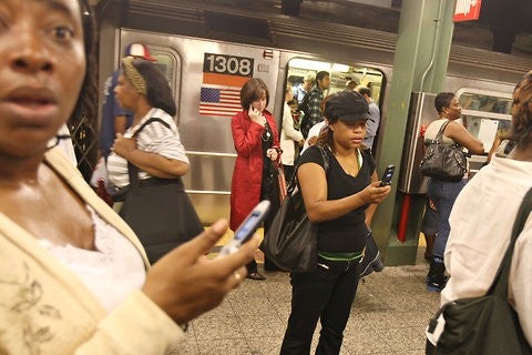 New Yorkers trying to use their cell phone on a Brooklyn subway platform in 2007; starting Tuesday in certain locations, AT&amp;T and T-Mobile users will be able to get a signal - Some NYC subway platforms to support AT&T and T-Mobile service starting Tuesday