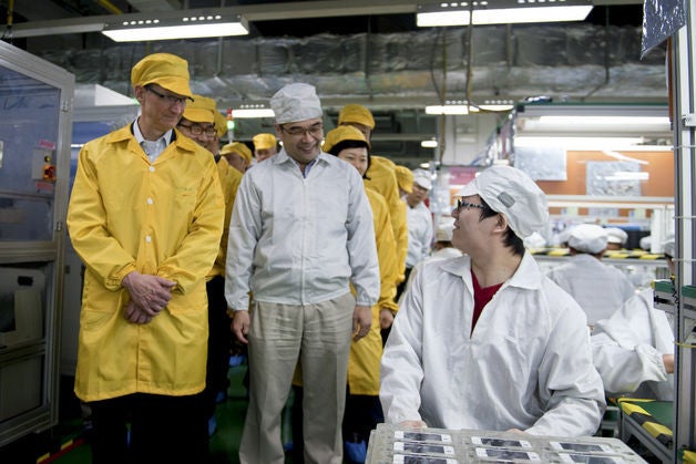 Tim Cook at the iPhone production line in the Foxconn plants - Tim Cook shakes hands with the Chinese VP en route to the Foxconn facilities