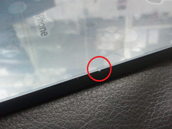 The circled area shows a nick on the side antenna of a new Apple iPhone 5 - Some new Apple iPhone 5 units are coming out of the box with scuff marks and dings