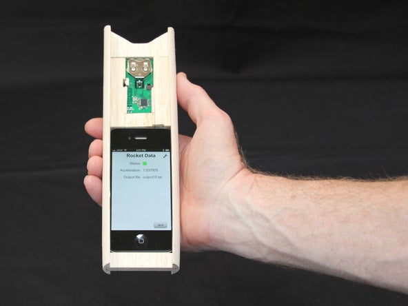 The Apple iPhone 4S fits snugly into the balsa wood holder - Watch as the Apple iPhone 4S blasts off inside a rocket