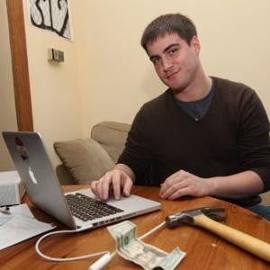 Nadav Nirenberg poses with the hammer and a $20 bill, the tools he used to get his phone back - Musician poses as girl online to get back his lost Apple iPhone 4