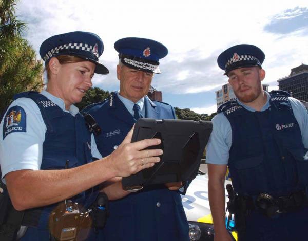 New Zealand Police Commissioner Peter Marshall checks out an Apple iPad during the trial - New Zealand police to buy 10,000 iOS devices, beating out Android and BlackBerry