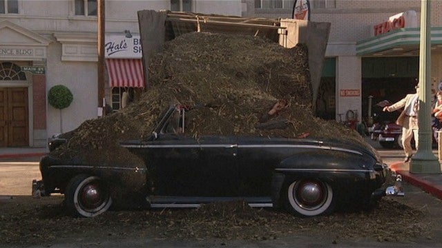 Real life follows fiction as this scene from Back to the Future shows Biff Tannen covered with manure after he drove his car into a trailer loaded with the stuff - Back to the Future: Texting and driving leads to crash with trailer hauling liquid manure
