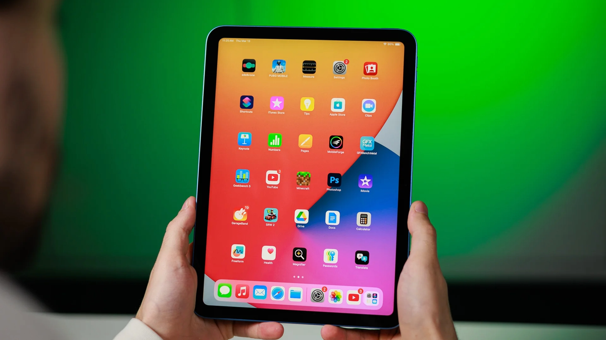 A photo of an iPad (A16) held in a person's hands.