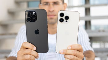 A man holding the Apple iPhone 16 Pro Max next to the iPhone 14 Pro Max