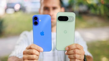 Man holding Apple iPhone 16 next to Google Pixel 9