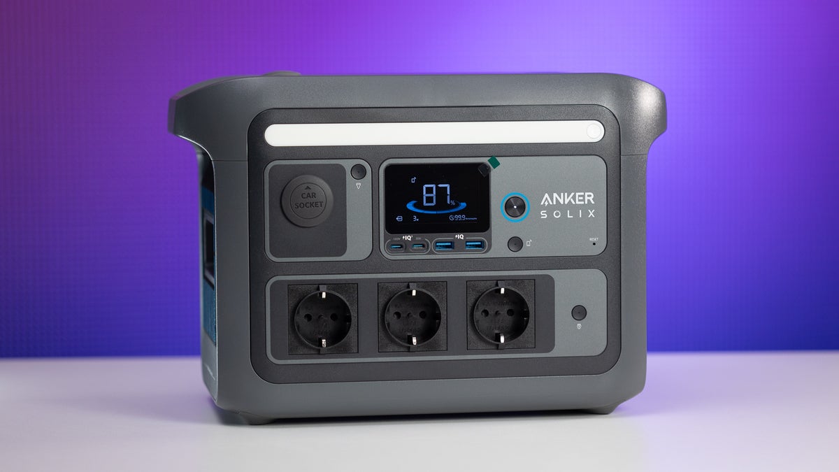 Anker Solix C800 Plus with its strip light and display turned on, placed on a white table against a blue background.