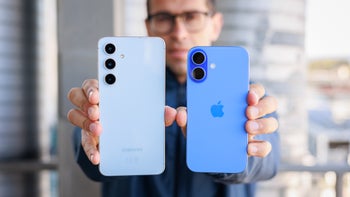 Person holding the S24 FE and iPhone 16 with their backs facing the camera.