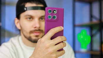 Man holding purple phone vertically.