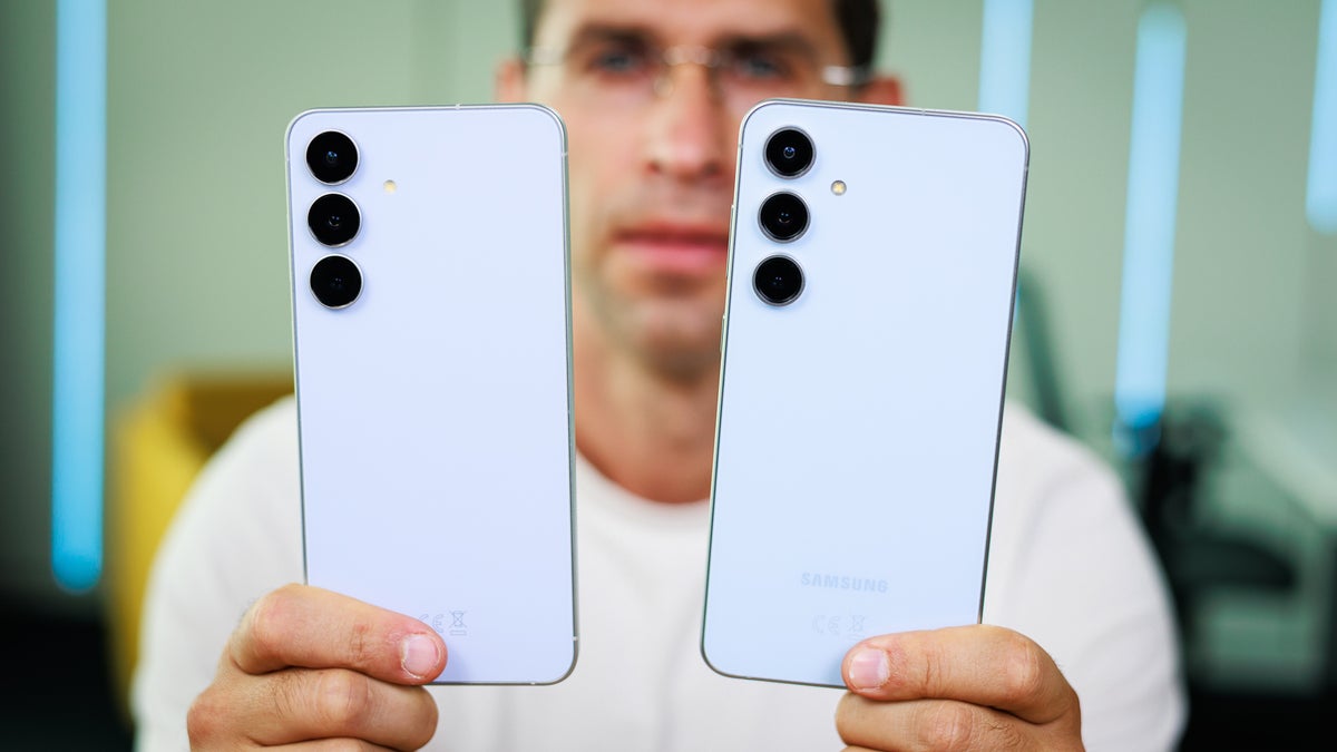 Close-up of a person holding the black Galaxy S25 FE blue S24 FE.