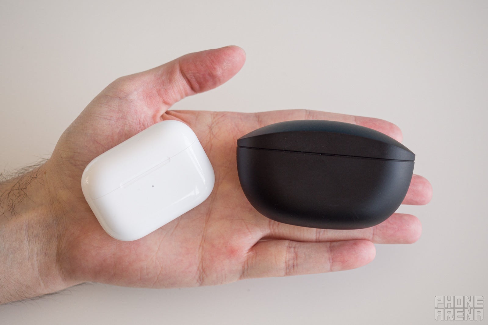 The AirPods Pro case (left) compared to the Sony WF-SP800N case - Sony WF-SP800N review