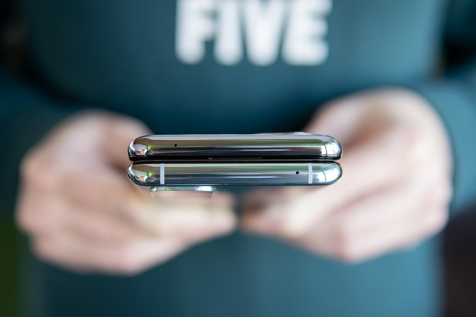 The OnePlus 9 (top) and the OnePlus 8T (bottom), with the latter having visible antenna lines - OnePlus 9 vs OnePlus 8T